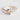 Gold-tone square zirconia ring with cluster side stones on a light gray surface