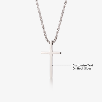 Silver-tone cross pendant necklace on a light background, custom engraved on both sides