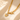 Gold-tone heart toggle necklace with Love You engraved heart on a cream fabric
