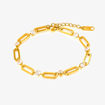 Gold-tone link chain bracelet with cubic zirconia stones and extension chain on a white background