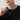 Man in a black T-shirt wearing the silver-tone barrel pendant necklace