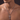man wearing a silver-tone rope chain necklace with a cubic zirconia cross pendant