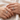 Couple resting hands together wearing matching custom engraved rings