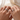 Couple holding hands wearing matching silver-tone rings without engraving