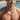 Man by a pool wearing the silver-tone curb chain necklace with an engraved oval plate