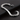 Silver-tone engraved chain bracelet with curved plate lying on a dark surface