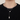 Silver-tone layered heart and bar necklace worn over a black sweater