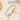 Gold-tone triple row stone bangle bracelet on cream textured surface